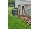 An air conditioner sits near firewood, ready to cool the home efficiently during warm seasons at 922 Eagle Brook Dr, Shelbyville, IN 46176