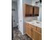 Bright bathroom with oak vanity, drawers, a built in mirror, and a toilet at 922 Eagle Brook Dr, Shelbyville, IN 46176