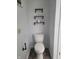 Cozy half bathroom features modern shelving for storage and tile flooring at 922 Eagle Brook Dr, Shelbyville, IN 46176
