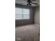 Cozy bedroom with a ceiling fan, natural light, and neutral carpet, creating a relaxing space at 922 Eagle Brook Dr, Shelbyville, IN 46176