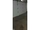 The bare garage features a garage door and concrete floors, ready for use at 922 Eagle Brook Dr, Shelbyville, IN 46176