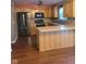 Well-lit kitchen with stainless steel appliances, wood cabinets, laminate countertops, and dark hardwood flooring at 922 Eagle Brook Dr, Shelbyville, IN 46176