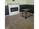 Living area with an electric fireplace and desk space, blending relaxation with functionality at 922 Eagle Brook Dr, Shelbyville, IN 46176