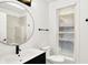Well-lit bathroom featuring a round mirror and a shower with stylish tiles at 925 Fayette St, Indianapolis, IN 46202