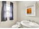 Classic bathroom featuring a pedestal sink, toilet, and medicine cabinet at 925 Fayette St, Indianapolis, IN 46202