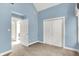 Bedroom featuring blue walls, double door closet, and ample natural light from a pair of large windows at 925 Fayette St, Indianapolis, IN 46202