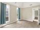 Bright bedroom featuring neutral walls, soft carpet, and plenty of natural light from two large windows at 925 Fayette St, Indianapolis, IN 46202