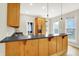 Well-lit kitchen featuring a breakfast bar, ample cabinet space, and modern appliances at 925 Fayette St, Indianapolis, IN 46202
