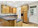 Bright kitchen with light wood cabinets, dark countertops, stainless steel appliances and open door to outside at 925 Fayette St, Indianapolis, IN 46202