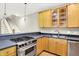 Well-equipped kitchen with stainless steel stove and sink, complemented by light wood cabinets at 925 Fayette St, Indianapolis, IN 46202