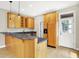 Kitchen with wooden cabinets, breakfast bar, and a door leading to the outdoors at 925 Fayette St, Indianapolis, IN 46202