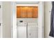 Convenient laundry room with a washer, dryer, and overhead storage cabinets at 925 Fayette St, Indianapolis, IN 46202