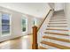 Bright staircase with hardwood treads and white risers, flooded with natural light from nearby windows at 925 Fayette St, Indianapolis, IN 46202
