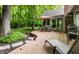 Tranquil backyard deck with an umbrella table, a brick chimney and lush greenery at 9445 Moorings Blvd, Indianapolis, IN 46256
