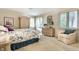 Bright bedroom features neutral carpet, white furniture and large windows with serene outside views at 9445 Moorings Blvd, Indianapolis, IN 46256