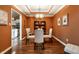 Formal dining room with modern chandelier, neutral paint, and adjacent kitchen at 9445 Moorings Blvd, Indianapolis, IN 46256