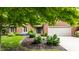 Charming brick home featuring an attached garage, beautifully landscaped front yard, and a covered entrance at 9445 Moorings Blvd, Indianapolis, IN 46256