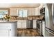 Kitchen featuring modern appliances, tiled backsplash, and lots of natural light at 9445 Moorings Blvd, Indianapolis, IN 46256