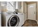 Bright laundry room with a white washer and dryer, cabinets, and a window at 9445 Moorings Blvd, Indianapolis, IN 46256