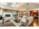 Bright living room with high ceilings, skylights, a cozy fireplace, and elegant hardwood flooring at 9445 Moorings Blvd, Indianapolis, IN 46256