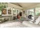 Cozy sunroom with comfortable seating, tiled floor, and sliding glass doors leading to the outdoors at 9445 Moorings Blvd, Indianapolis, IN 46256