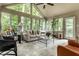 Bright sunroom featuring lots of light, a ceiling fan, and a neutral-colored sofa at 9445 Moorings Blvd, Indianapolis, IN 46256