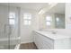 Bright bathroom boasts a double vanity, gray ceramic tile and a glass shower at 9741 Oleander Dr, Fishers, IN 46250