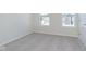 Carpeted bedroom featuring white trim, a double hung window and a door to hall at 9741 Oleander Dr, Fishers, IN 46250