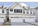 New construction townhome featuring white siding, black shutters, and attached two car garage at 9741 Oleander Dr, Fishers, IN 46250