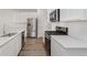 Modern kitchen featuring stainless steel appliances, white countertops, cabinetry, and hardwood flooring at 9741 Oleander Dr, Fishers, IN 46250
