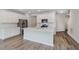 Spacious kitchen featuring stainless steel appliances, white countertops, cabinetry, and hardwood flooring at 9741 Oleander Dr, Fishers, IN 46250