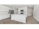 Kitchen with stainless steel appliances, island, and white cabinets at 9741 Oleander Dr, Fishers, IN 46250