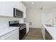 Kitchen featuring white cabinets, stainless steel appliances, and black gas range at 9741 Oleander Dr, Fishers, IN 46250