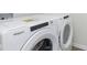 Image of a new, white, stacked washer and dryer with modern features at 9741 Oleander Dr, Fishers, IN 46250