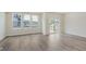 Bright living room with hardwood floors, multiple windows, and access to an outdoor deck at 9741 Oleander Dr, Fishers, IN 46250