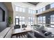 Open lounge area with modern seating, billiards table, and natural light from large windows at 9741 Oleander Dr, Fishers, IN 46250