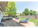 Well-maintained backyard with wooden deck, comfortable seating, and a green lawn area at 977 Canary Creek Dr, Franklin, IN 46131
