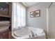 This bathroom features a white soaking tub and a wooden cabinet with towels at 977 Canary Creek Dr, Franklin, IN 46131