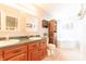 Well-lit bathroom featuring double sinks, wooden cabinets and a soaking tub at 977 Canary Creek Dr, Franklin, IN 46131