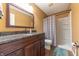 Bathroom featuring granite vanity top, wood cabinets, a shower and patterned shower curtain at 977 Canary Creek Dr, Franklin, IN 46131