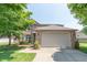Charming two-story brick home with a well-maintained lawn and mature trees under a clear sky at 977 Canary Creek Dr, Franklin, IN 46131