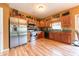Well-lit kitchen featuring stainless steel appliances, hardwood floors, and ample cabinet space at 977 Canary Creek Dr, Franklin, IN 46131