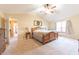 A sun-lit main bedroom shows a large wooden bed frame and side tables at 977 Canary Creek Dr, Franklin, IN 46131