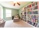 This office features a cozy chair, window with natural light, and a wall-to-wall bookshelf at 977 Canary Creek Dr, Franklin, IN 46131