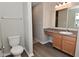 Bathroom with vinyl floors, large vanity and a toilet at 10431 Bellchime Ct, Indianapolis, IN 46235