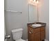Bathroom featuring a vanity with cabinets for storage, granite countertop and a square mirror and toilet at 10431 Bellchime Ct, Indianapolis, IN 46235