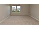 Bedroom with neutral walls and carpeting with bright windows offering natural light and a neighborhood view at 10431 Bellchime Ct, Indianapolis, IN 46235