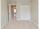 Well-lit bedroom features carpeted floors and a sliding door closet offering practical storage space and easy organization at 10431 Bellchime Ct, Indianapolis, IN 46235