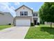 Charming two-story home featuring a two-car garage, well-maintained lawn, and traditional design elements at 10431 Bellchime Ct, Indianapolis, IN 46235