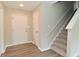 Bright foyer featuring hardwood flooring, staircase, and a white front door for a welcoming entrance at 10431 Bellchime Ct, Indianapolis, IN 46235